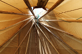 Ermineskin Elementary students entering tipi